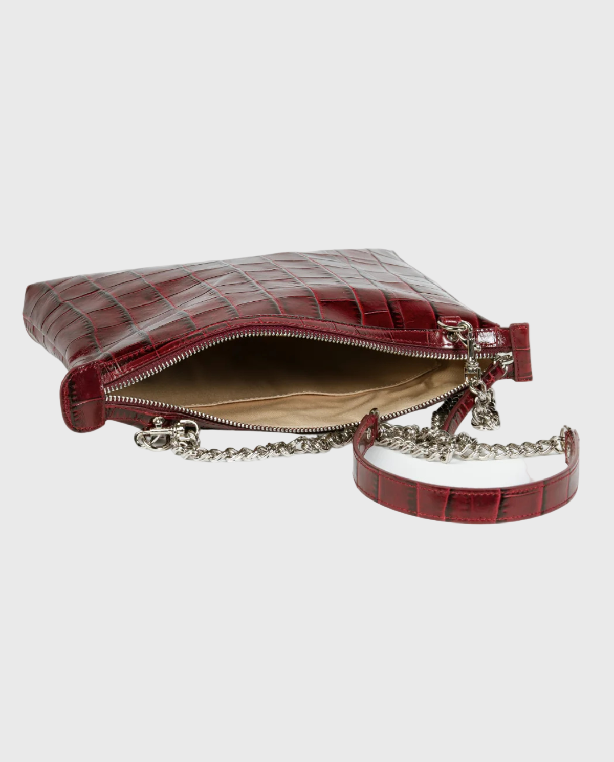 Red leather handbag with chain strap on a white background