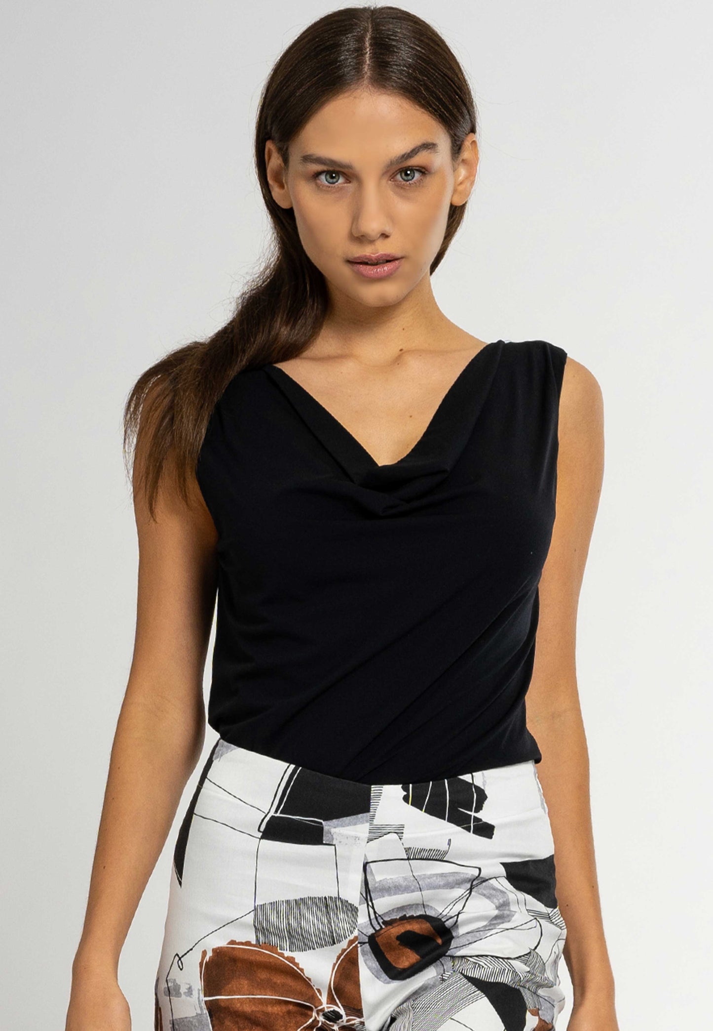 Looking for a chic and feminine top that flatters your figure? Look no further than the Lori cowl neck sleeveless top. Made from luxurious Italian viscose, this figure-hugging top is perfect for any occasion.Italian viscose top, cowl neck top, sleeveless top, regular fit top, hand wash only